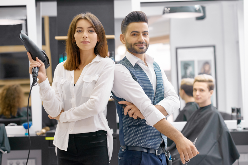 two-hairstylers-posing-standing-modern-spacy-beaty-salon